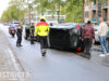 Personenauto op zijn kant na ongeval met bedrijfsbusje Erasmusweg Den Haag