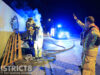 Brandweer blust felle containerbrand tegen hekwerk van scheepswerf Rotterdamseweg Delft